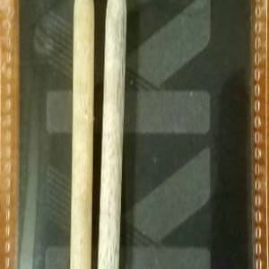 May include: A pair of 5 inch, US size 6,  Lykke Driftwood wooden knitting needles. The needles are natural wood color and have black tips.