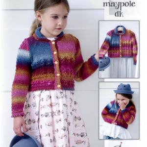 May include: A multi-colored striped cardigan with a button closure. The cardigan is made with a soft yarn and has a relaxed fit. The model is wearing a white skirt with a pattern of fish and candy.