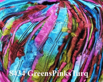 May include: A skein of yarn with a mix of green, pink, and turquoise colours. The yarn has a fuzzy texture and is made of multiple strands.