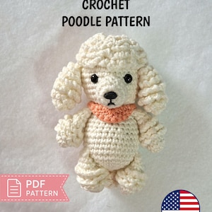 May include: A cream-colored crochet poodle toy with a textured curly coat, black plastic eyes, a black nose, and a peach-colored collar. The text CROCHET POODLE PATTERN and PDF PATTERN are visible, along with a circular United States flag icon.