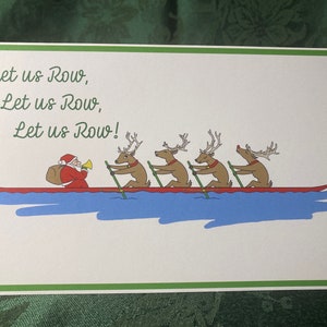 May include: A Christmas card with a white background and green border. The card features a red boat with Santa Claus rowing with four reindeer. The text on the card reads "Let us Row, Let us Row, Let us Row!"
