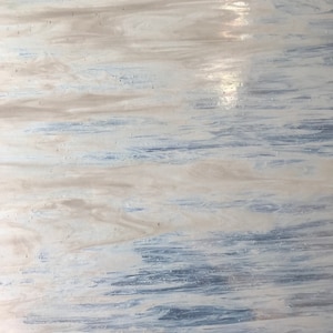 May include: Abstract art piece with a flowing design. The artwork features a blend of white, light blue, and beige hues, creating a sense of movement and texture. The colors are swirled and layered, resembling a natural landscape.