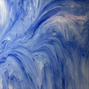 May include: Abstract art piece with a flowing design in shades of blue and white. The artwork features a marbled effect, with swirling patterns and a glossy finish. The color palette evokes a sense of water or sky.