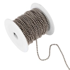 May include: A spool of silver ball chain, with a length of chain extending from the spool.