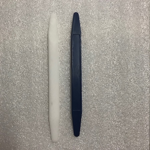 May include: Two plastic tools for prying open things. One is white and the other is blue.