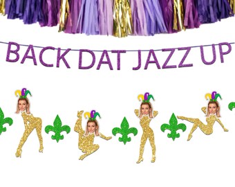 May include: A purple and gold banner with the text "Back Dat Jazz Up" and four gold glitter cutouts of a person with a purple and green jester hat. The cutouts are in different poses and have a face cutout.