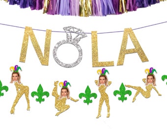 May include: Gold glitter NOLA banner with a silver glitter ring and green and gold glitter figures with faces.