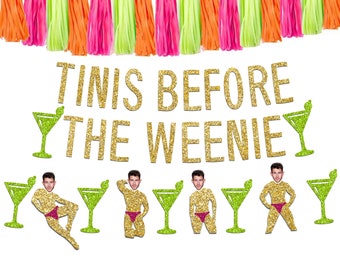 May include: Gold glitter banner with the text "Tinis Before The Weenie" and green glitter martini glasses. There are also green glitter martini glasses and gold glitter figures of a person in a swimsuit.