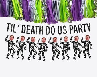 May include: A festive Halloween party banner with the text "Til' Death Do Us Party" above dancing skeleton figures with human faces. The banner is decorated with purple, green, and silver tassel garland.