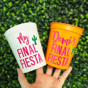 May include: Two white plastic cups with pink and green lettering. One cup says "My Final Fiesta" and the other says "Demi's Final Fiesta".