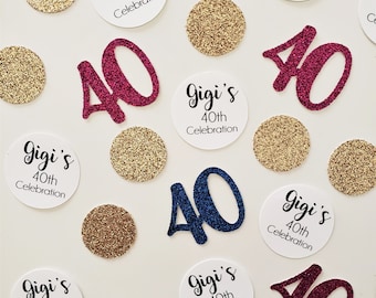 May include: A collection of confetti for a 40th birthday party. The confetti includes gold glitter circles, white circles with the text "Gigi's 40th Celebration", and large numbers 40 in pink, blue, and burgundy.