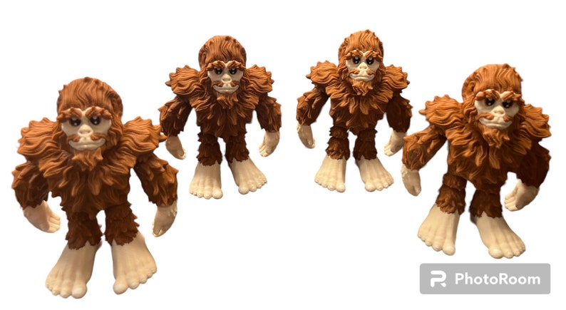 May include: Four brown furry Bigfoot figures with white faces and hands. The figures are standing on a white background.