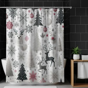 May include: White Christmas-themed shower curtain with a repeating pattern of snowflakes, Christmas trees, reindeer, and ornaments in shades of gray, red, and black. The curtain is hanging in front of a white bathtub, with a black tiled wall in the background.