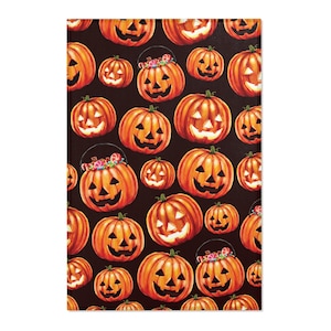 May include: A fabric pattern featuring a repeating design of orange jack-o'-lanterns on a dark brown background. Some pumpkins are depicted as buckets filled with colorful candies, while others are standard carved pumpkins with glowing faces.