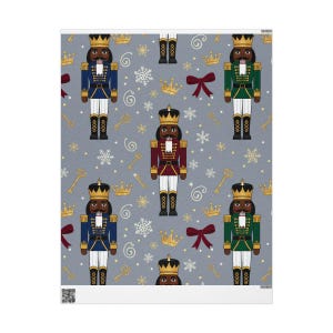 May include: A patterned fabric featuring repeating images of nutcrackers in blue, green, and red uniforms, each wearing a gold crown. The background is a light gray with gold keys, snowflakes, and bows.