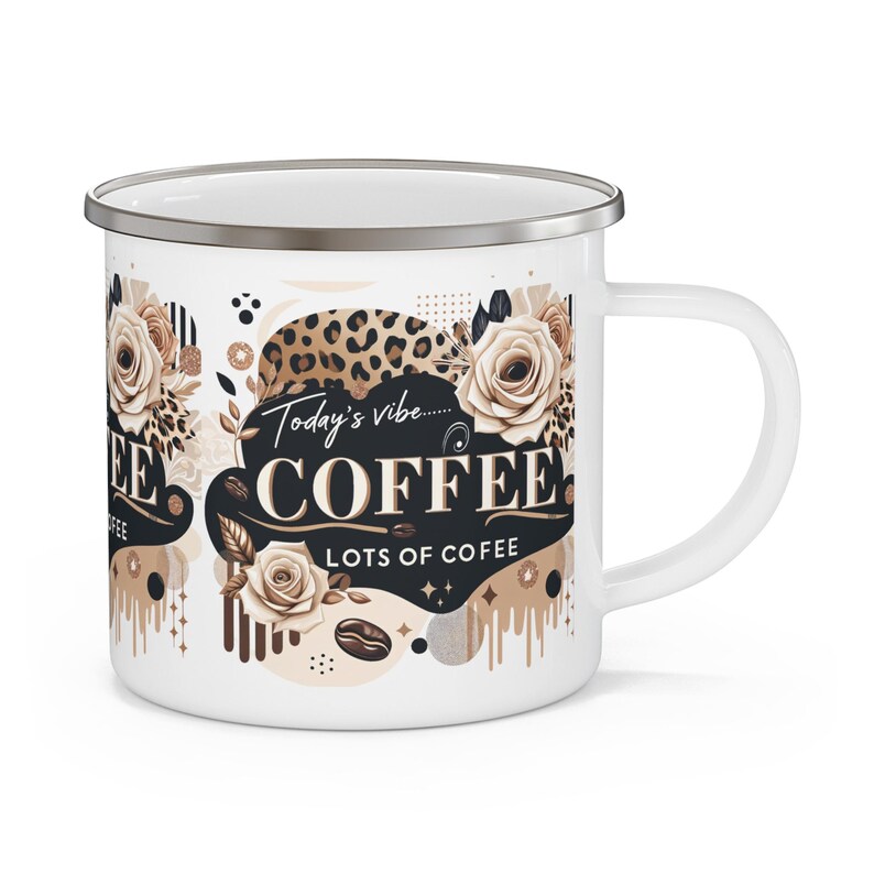 May include: White enamel coffee mug with a silver rim and handle. The mug features a design with roses, leopard print, and the words "Today's vibe... COFFEE LOTS OF COFEE" in a decorative font. The mug has a coffee bean graphic.