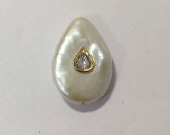Drop shaped Pearl inlaid with diamond polki and 24k gold.