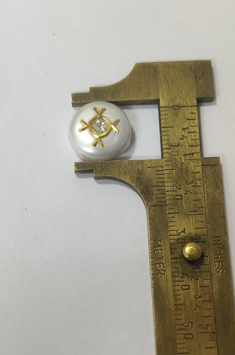 inlaid Pearl encrusted with diamond polki and gold.