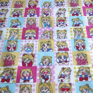 May include: A white fabric with a repeating pattern of a cartoon character with blonde hair and different facial expressions. The character is wearing a blue sailor uniform with a red bow. The background is a pink and yellow checkered pattern.