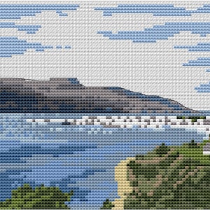 May include: A cross-stitch pattern of a coastal scene with a dark gray mountain in the background, a blue body of water in the foreground, and green trees at the bottom.