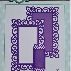 May include: A package of three purple steel craft dies for creating frames and tags. The dies feature ornate, refined rectangular frame designs. The package includes the text "Creative Expressions" and "Craft Dies by Sue Wilson".