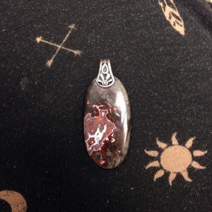 Jasper cabochon pendant with epoxied sterling silver bail.