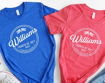 May include: Two t-shirts with a white circle design featuring the text "Williams Fourth of July 2023 Pompano Beach, FL". One shirt is blue and the other is red.