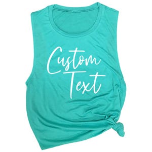 May include: A turquoise sleeveless muscle tank top with the text "Custom Text" printed in white.