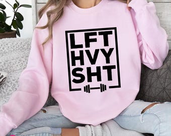 May include: Pink sweatshirt with a black box that says "LFT HVY SHT" with a barbell underneath.
