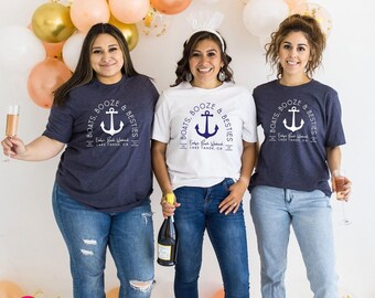 May include: Two dark heather navy blue t-shirts and one white t-shirt, each featuring a circular graphic with an anchor and the text 'BOATS, BOOZE & BESTIES', 'Emily's Bach Weekend', and 'LAKE TAHOE, CA' with the years 20 and 23.
