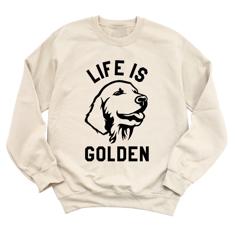 May include: A beige sweatshirt with a black silhouette of a golden retriever and the text "Life is Golden".