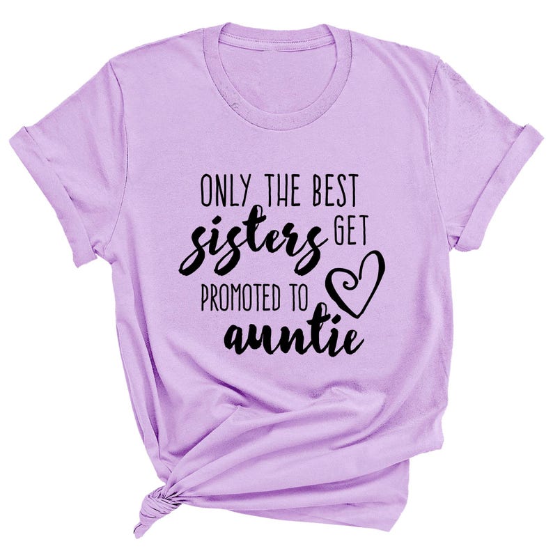 May include: A light purple t-shirt with rolled-up sleeves. The shirt features the text "ONLY THE BEST sisters GET promoted to auntie" in black script and a heart graphic. The shirt is knotted at the bottom.