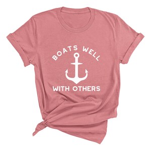 May include: A pink t-shirt with a white anchor and the text "Boats well with others".