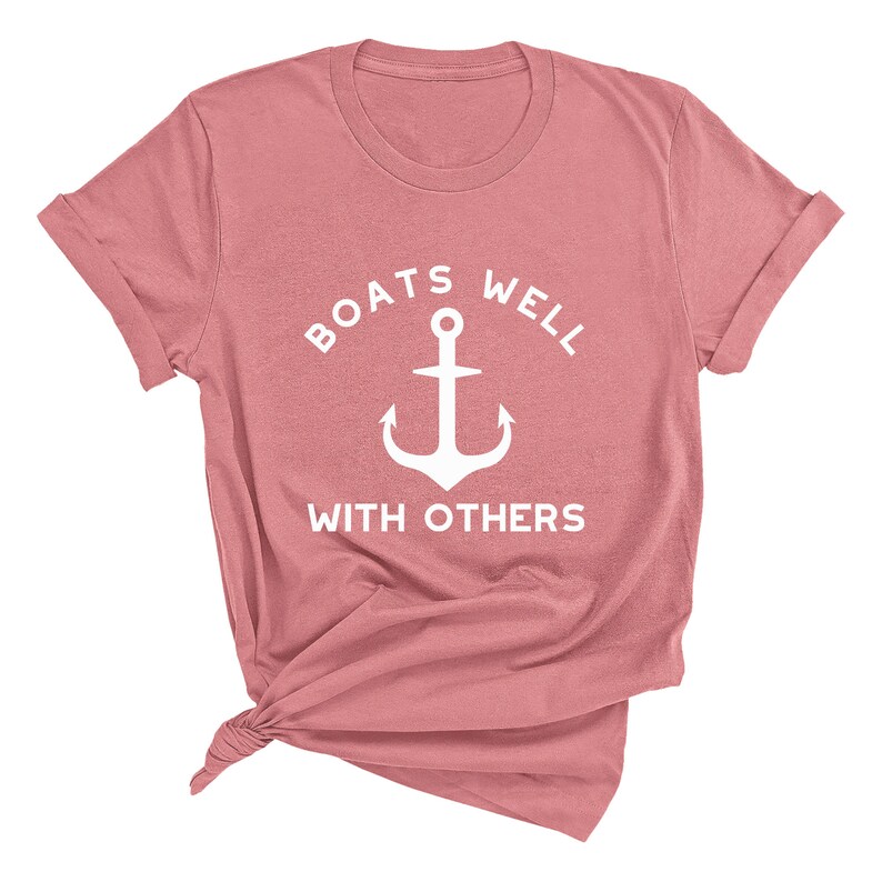 May include: A pink t-shirt with a white anchor and the text "Boats well with others".
