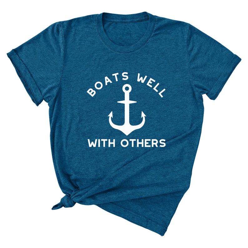 May include: A teal blue t-shirt with a white anchor and the text "Boats Well With Others".