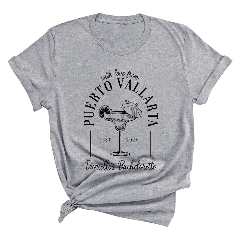 May include: Gray t-shirt with black text that reads "with love from PUERTO VALLARTA EST. 2024" and "Dant&eacute;lle's Bachelorette" with a drawing of a margarita glass with a lime and an umbrella.