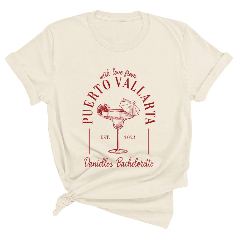 May include: A white t-shirt with a red circle design that says "Puerto Vallarta" with a margarita glass and the text "with love from" and "Danielle's Bachelorette" with the year "2024" and "EST."
