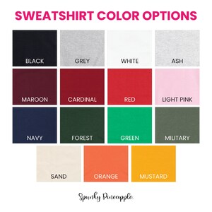 May include: A color chart showing 15 different sweatshirt color options. The colors are: black, grey, white, ash, maroon, cardinal, red, light pink, navy, forest, green, military, sand, orange, and mustard.