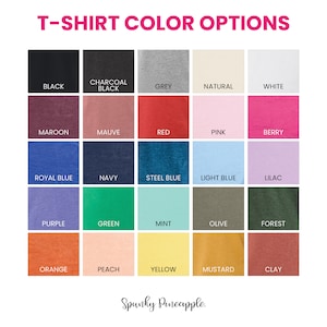 May include: A chart showing 18 different t-shirt color options. The colors are arranged in a grid with five columns and four rows. The colors include black, charcoal, grey, natural, white, maroon, mauve, red, pink, berry, royal blue, navy, steel blue, light blue, lilac, purple, green, mint, olive, forest, orange, peach, yellow, mustard, and clay.