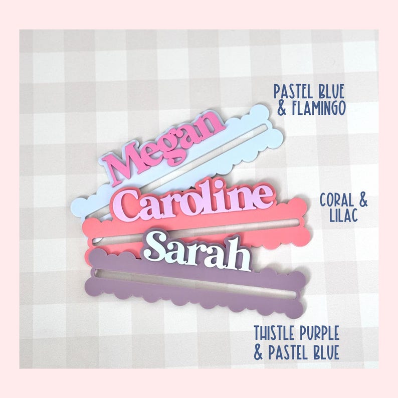 May include: Three personalized name cutouts in pastel colors. The names are "Megan", "Caroline", and "Sarah". Each name is a different color, with the text "PASTEL BLUE & FLAMINGO", "CORAL & LILAC", and "THISTLE PURPLE & PASTEL BLUE" next to each name.