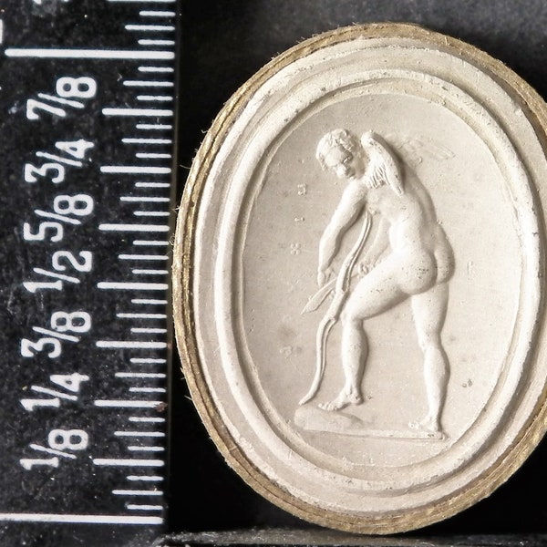 Antique grand tour circa 1820 plaster intaglio cameo 237 shows Cupid breaking his bow