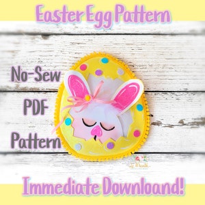 May include: A no-sew PDF pattern for an Easter egg with a bunny face. The egg is yellow with pink ears and a white face. The pattern is available for immediate download.