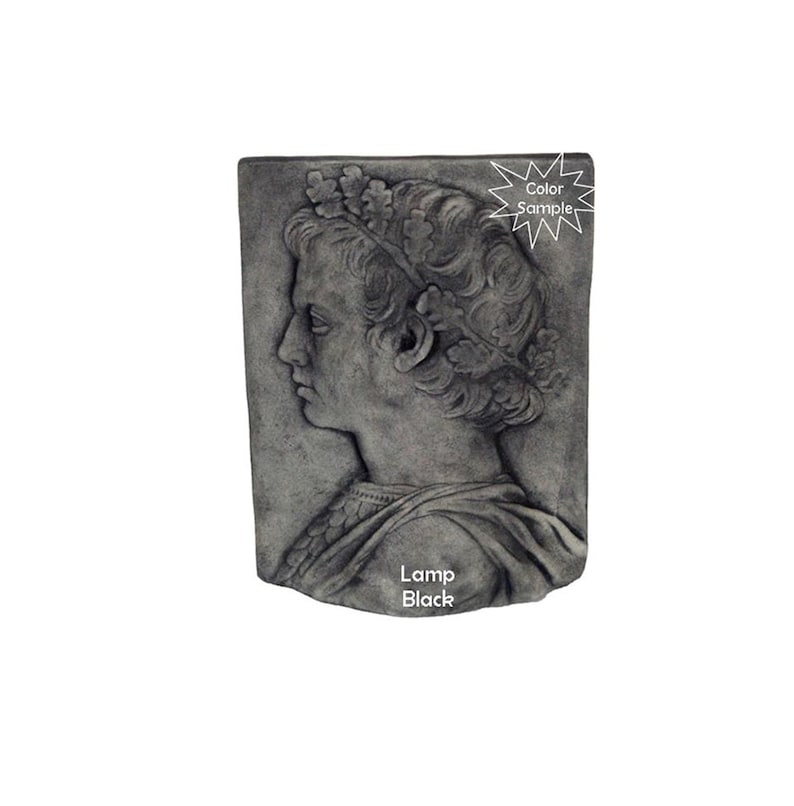 May include: A gray stone wall plaque with a bas-relief sculpture of a person wearing a crown of leaves. The plaque has the text "Lamp Black" at the bottom.