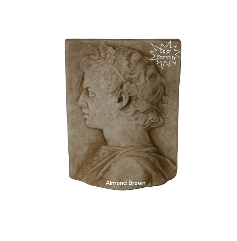 May include: A sculpted wall plaque featuring a profile of a person wearing a crown. The plaque is made of a light brown material and has a textured surface. The text "Almond Brown" is printed below the plaque.