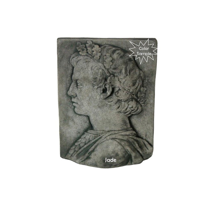 May include: A gray stone wall plaque with a detailed relief sculpture of a person's head and shoulders. The person is wearing a crown and a robe. The plaque is labeled "Jade".