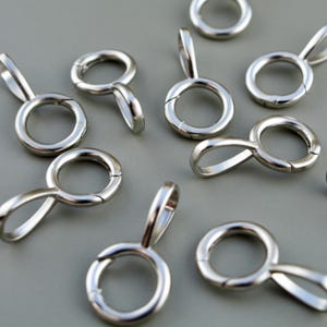 May include: A white ceramic mug with a black handle and the text "But First, Coffee" in a handwritten style. The mug is on a white surface.