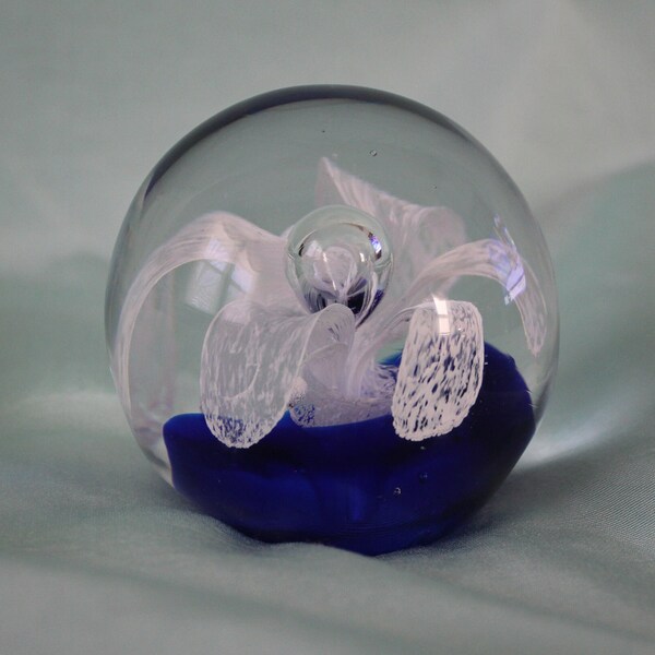 Vintage Globe Paperweight with Bubbled Center White Flower Resting on Deep Blue Cushion  Handblown