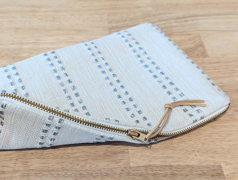 Modern ivory makeup pouch with sky blue stripes image 1
