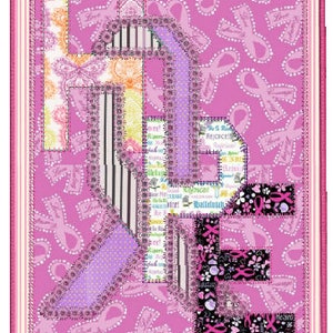May include: A pink fabric patchwork quilt block with the word "HOPE" spelled out in large letters. The letters are made of different fabrics with pink, purple, black, and white patterns. The background is pink with a pattern of pink ribbons.