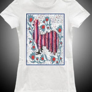 May include: White t-shirt with a colorful rooster illustration. The rooster is pink and blue with white stripes and is surrounded by blue and red flowers.